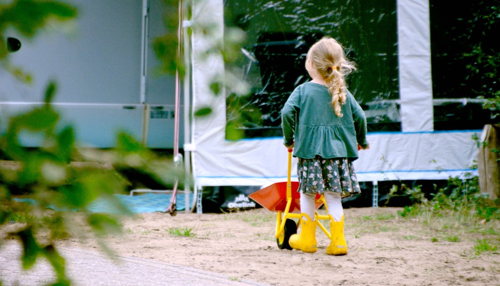 girl rubberboots campsite  wheelbarrow